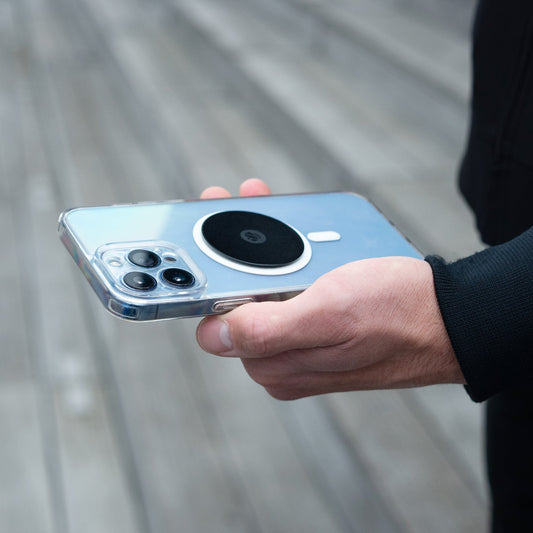 Smartphone with Shapeheart metal plate in hand, ideal for secure phone attachment on Shapeheart mount