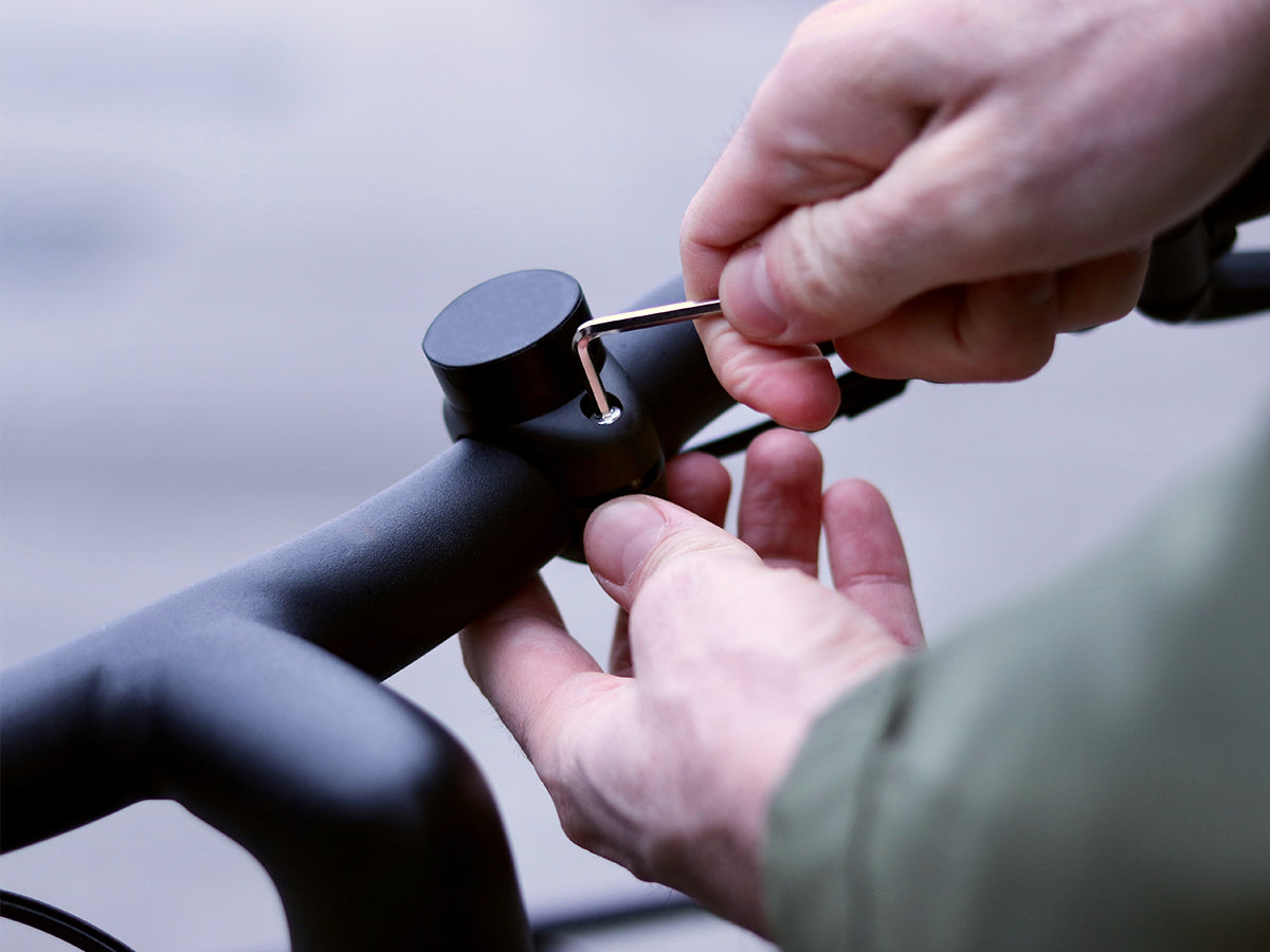 Utilisation d'une clé Allen pour visser le support de téléphone magnétique Shapeheart sur le guidon du vélo